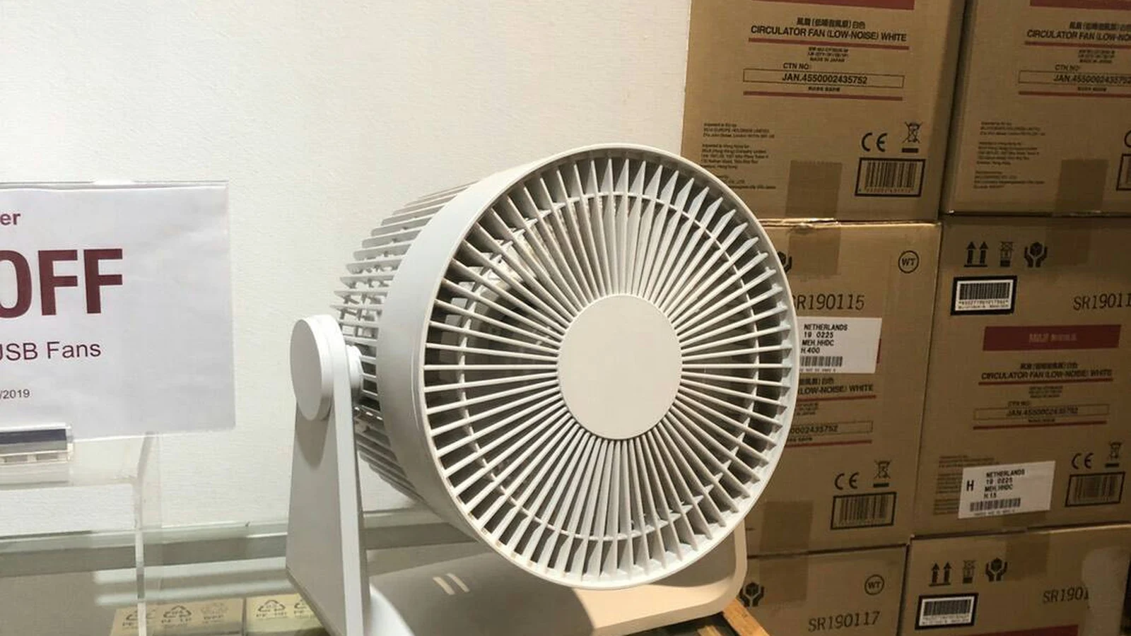 Small desktop fan on a clean work surface for compact cooling context